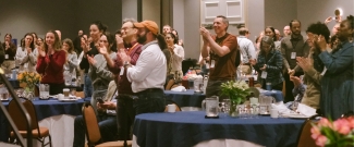 People standing and clapping
